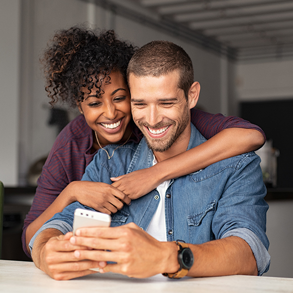 Smiling couple looking at phone