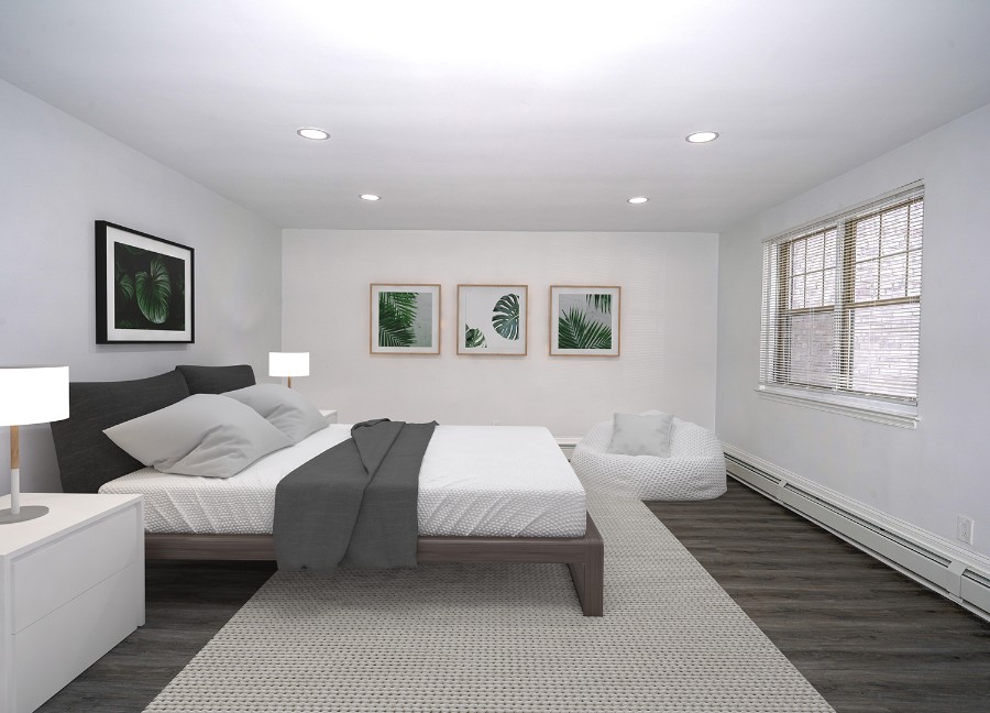 staged bedroom with white furniture and rug