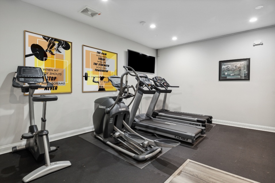 exercise equipment indoors with a tv on the wall