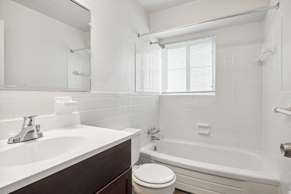 clean white bathroom with a dark wood cabinet