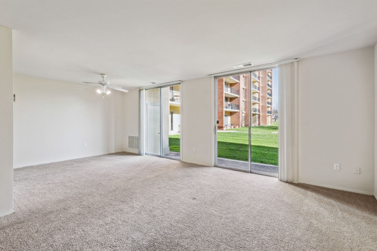 carpeted living space with class sliding door to outside