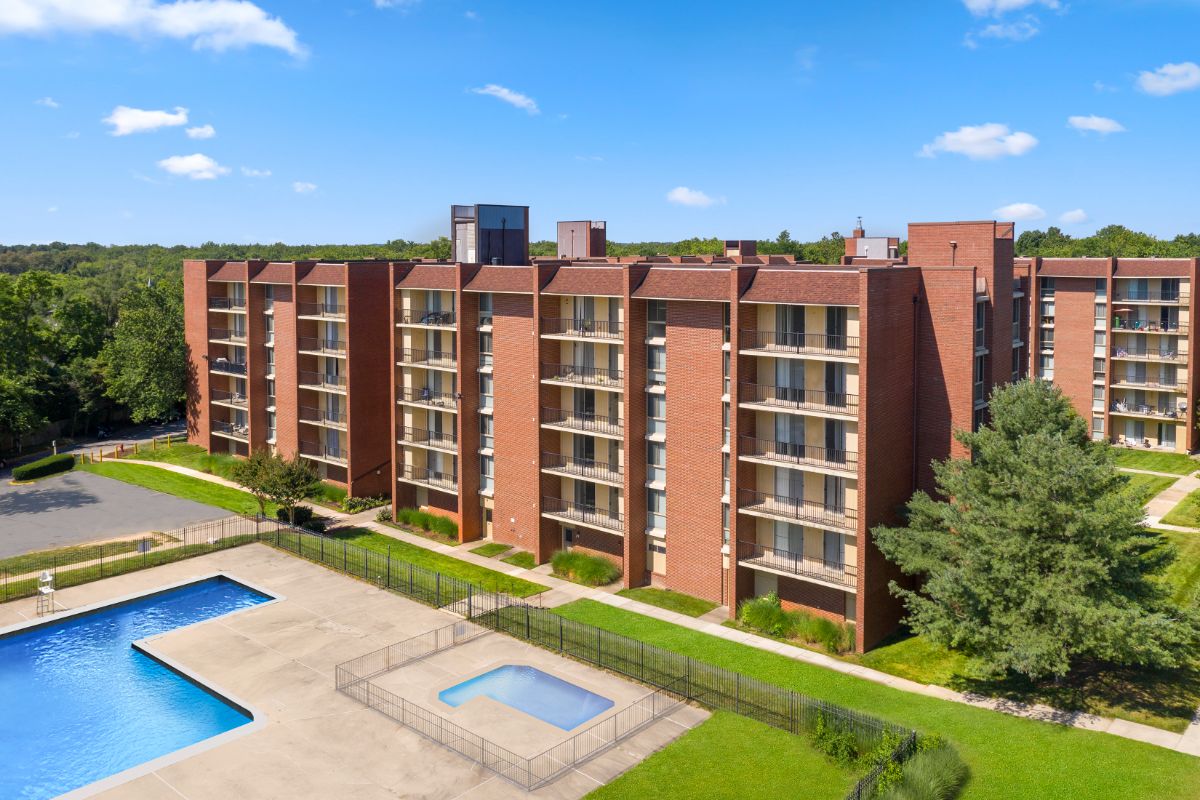 closer view of building exterior including pool