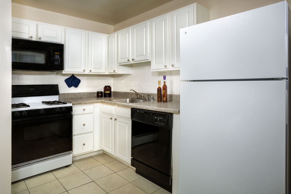 kitchen with black appliances and white cabinets